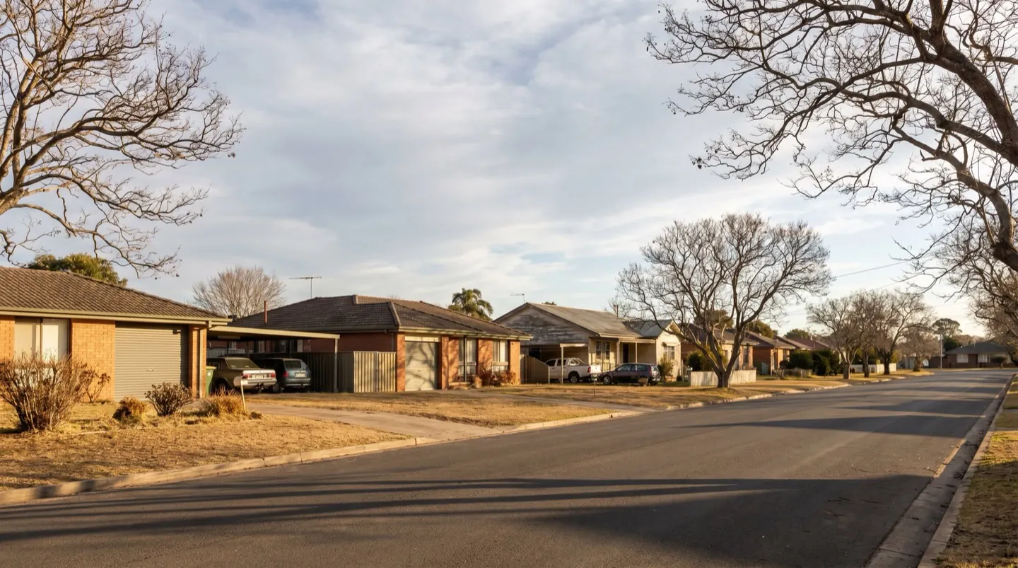 An established Cessnock residential street of brick and weatherboard homes with roller doors and carports